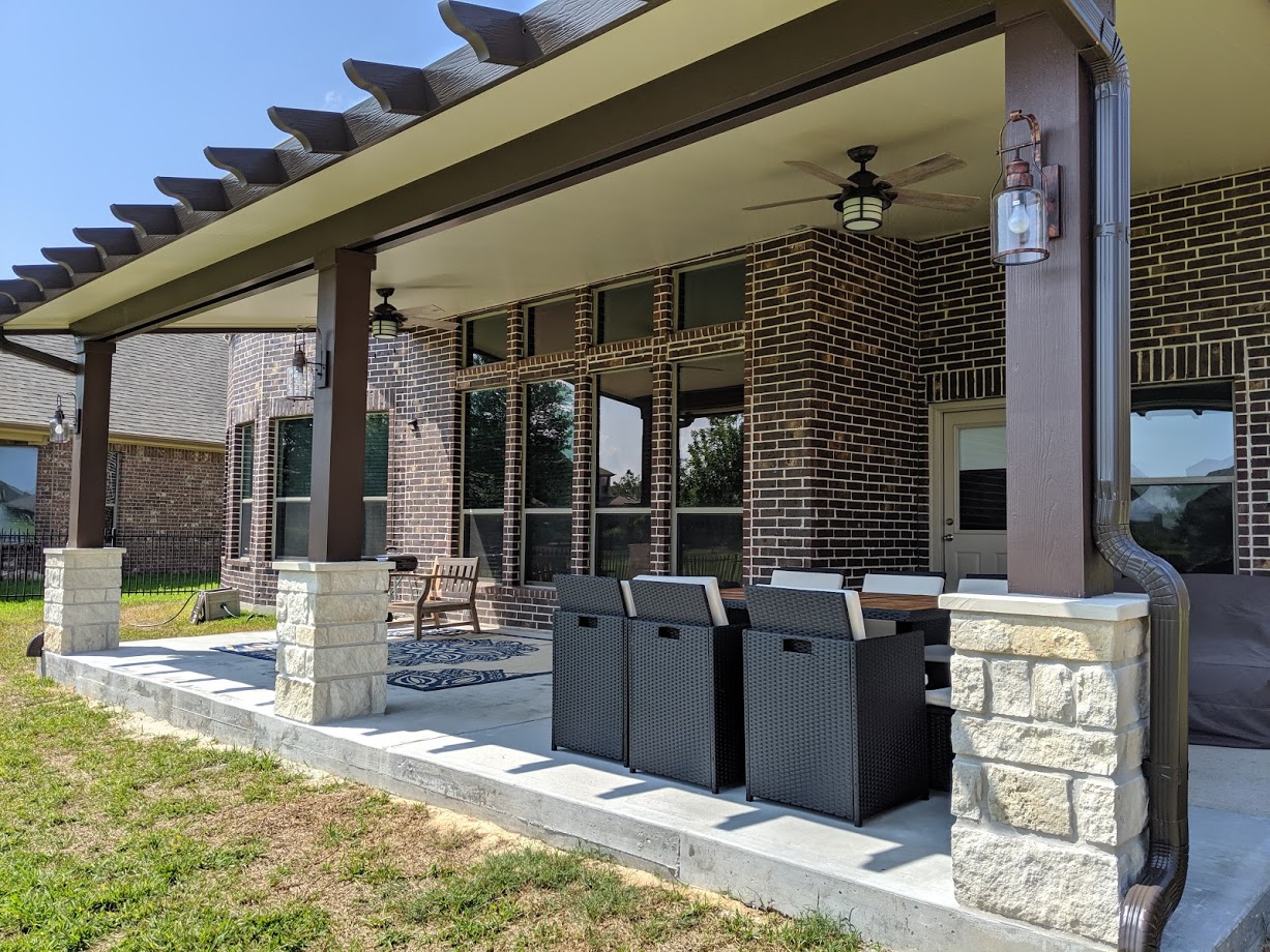 Patio Cover with stone column bases in a backyard in Houston TX