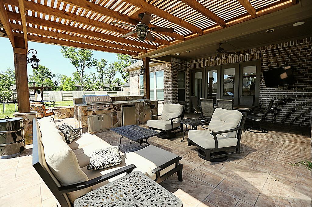 Pergola in Round Rock TX with ceiling fan, lighting and outdoor kitchen