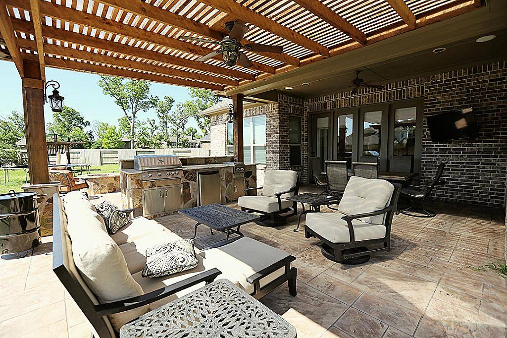 Covered Patios in Houston with a cedar pergola and outdoor kitchen